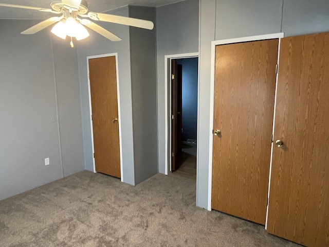 unfurnished bedroom with ceiling fan and light carpet