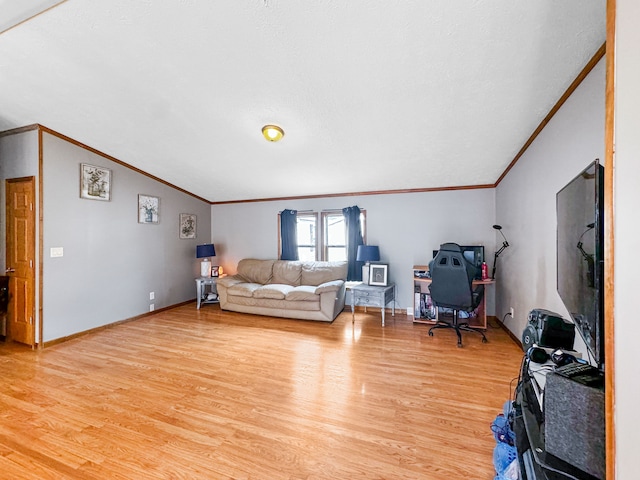 living room featuring vaulted ceiling, crown molding, and light hardwood / wood-style floors