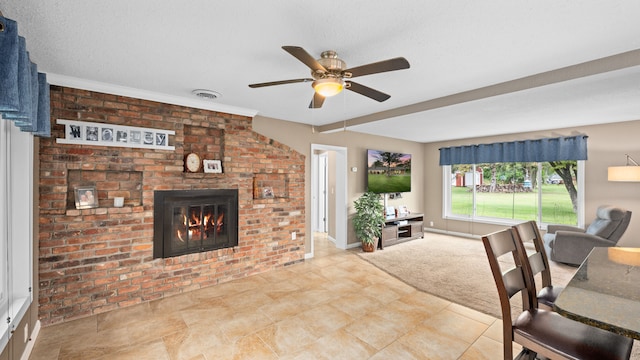 living room with baseboards, visible vents, a ceiling fan, carpet floors, and a fireplace