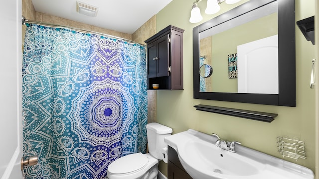 bathroom with toilet, visible vents, and vanity