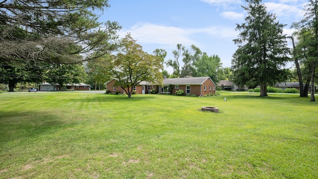 view of yard with an outdoor fire pit