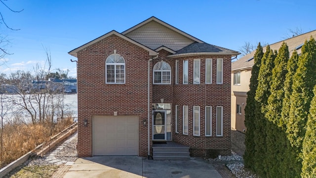 traditional-style house featuring brick siding, driveway, and an attached garage