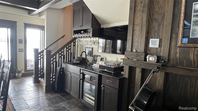 11720 Easy St, Kewadin, MI 49648 - kitchen with wine cooler, stone tile floors, and a sink