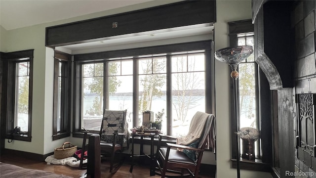 11720 Easy St, Kewadin, MI 49648 - dining room featuring a water view, wood finished floors, and baseboards