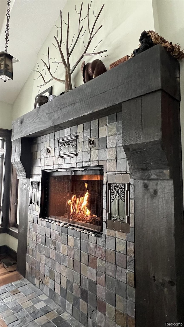 11720 Easy St, Kewadin, MI 49648 - detailed view of a warm lit fireplace and wood finished floors