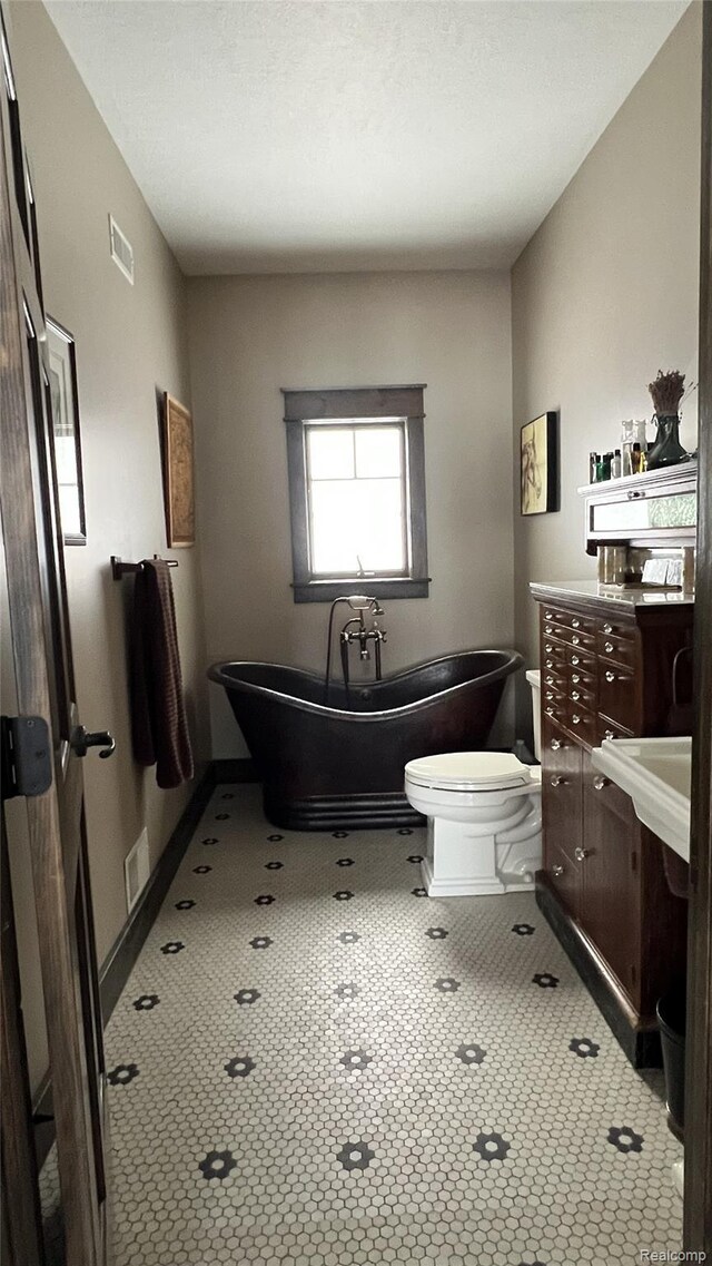 11720 Easy St, Kewadin, MI 49648 - full bathroom with a soaking tub, vanity, and toilet