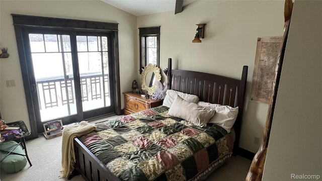 11720 Easy St, Kewadin, MI 49648 - bedroom featuring light carpet, access to exterior, and lofted ceiling