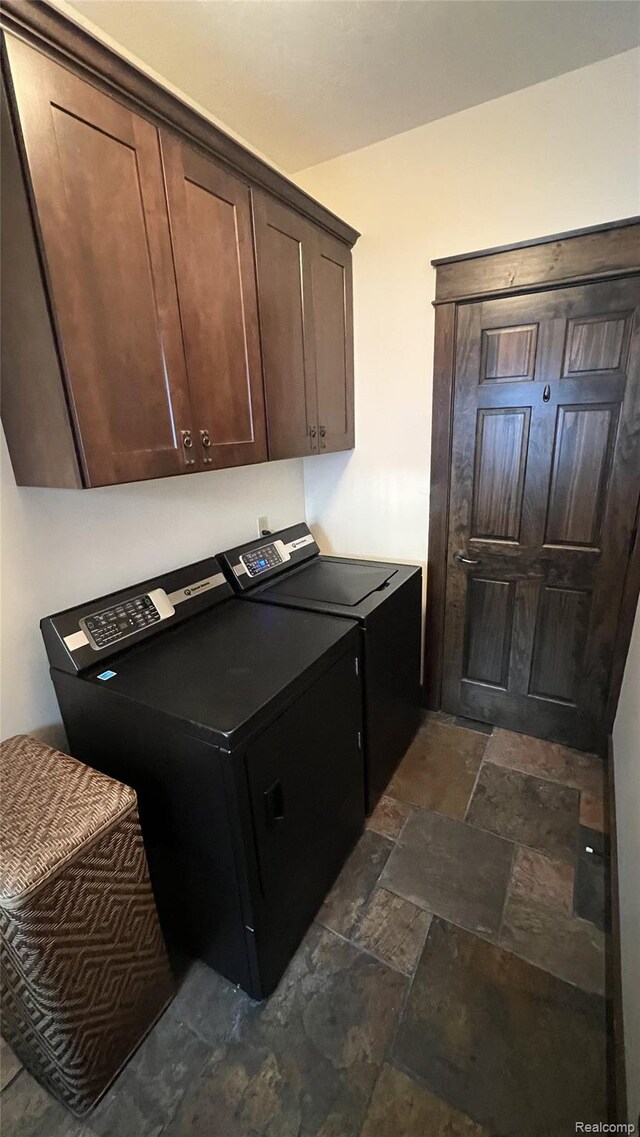 11720 Easy St, Kewadin, MI 49648 - laundry room featuring washer and dryer, cabinet space, stone tile floors, and a desk