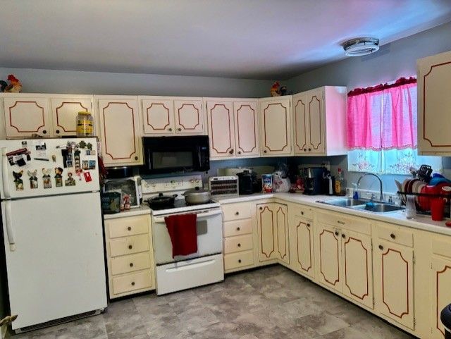 kitchen featuring sink and white appliances