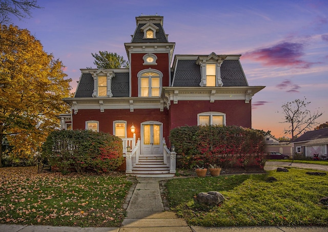 italianate home featuring a yard