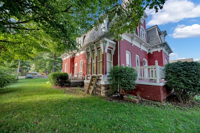 view of side of property with a yard