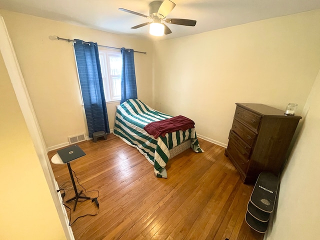 bedroom with hardwood / wood-style floors and ceiling fan