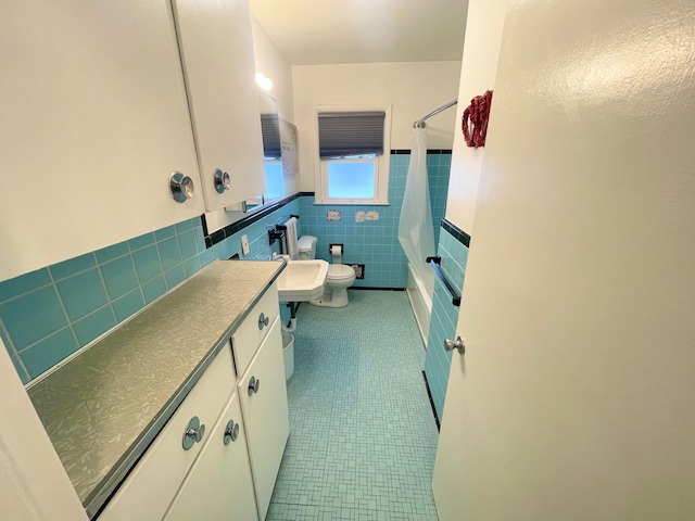 bathroom with a wainscoted wall, toilet, tile walls, tile patterned flooring, and shower / tub combo with curtain