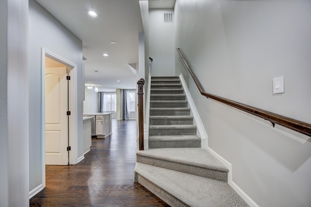 stairway featuring wood-type flooring