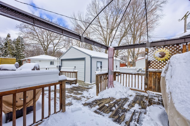 snowy yard featuring a garage and an outdoor structure