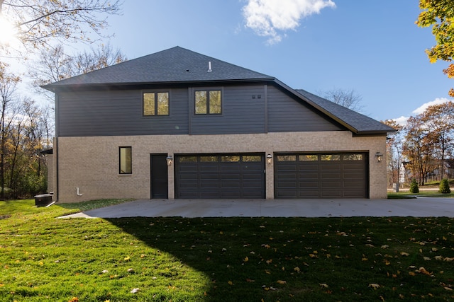 view of side of home with a garage and a yard