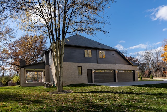 view of side of property featuring a garage and a yard