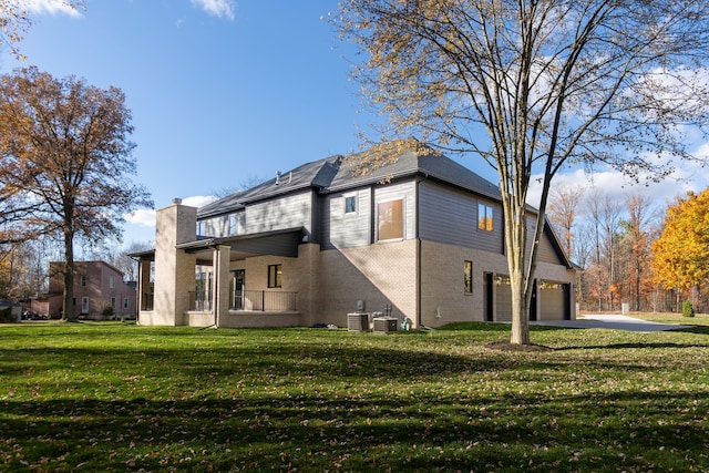 view of property exterior featuring a yard, a garage, and central AC unit