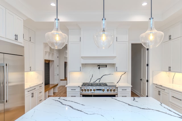 kitchen with hanging light fixtures, white cabinets, and appliances with stainless steel finishes