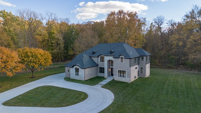 french country inspired facade with a front lawn