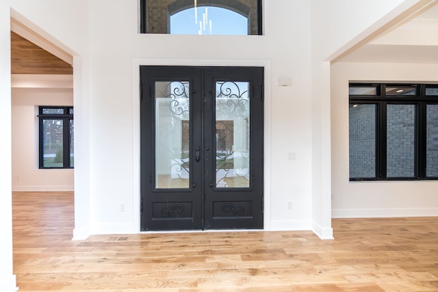 entrance foyer with light wood-type flooring and french doors