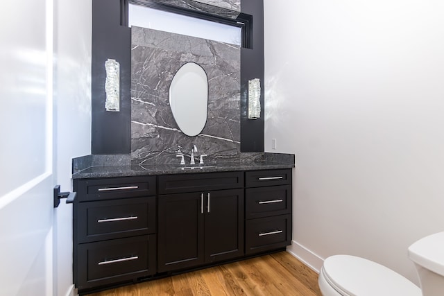 bathroom with vanity, backsplash, hardwood / wood-style flooring, and toilet