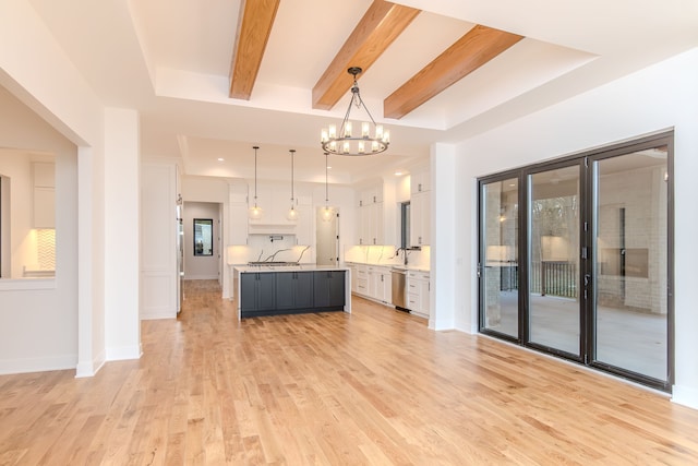 kitchen with white cabinetry, dishwasher, a kitchen island, pendant lighting, and light hardwood / wood-style floors