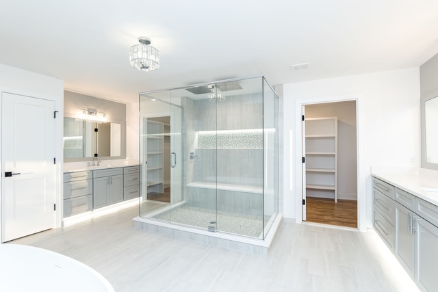 bathroom with vanity and a shower with door