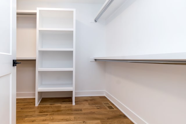 walk in closet with wood-type flooring