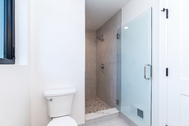 bathroom featuring toilet and walk in shower