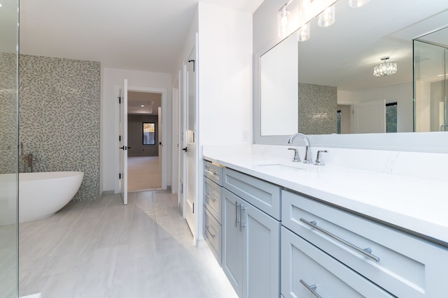 bathroom with vanity, a tub to relax in, and tile patterned floors