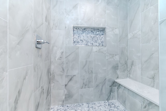 bathroom featuring tiled shower