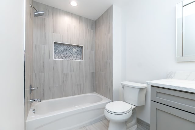 full bathroom featuring vanity, toilet, and tiled shower / bath combo