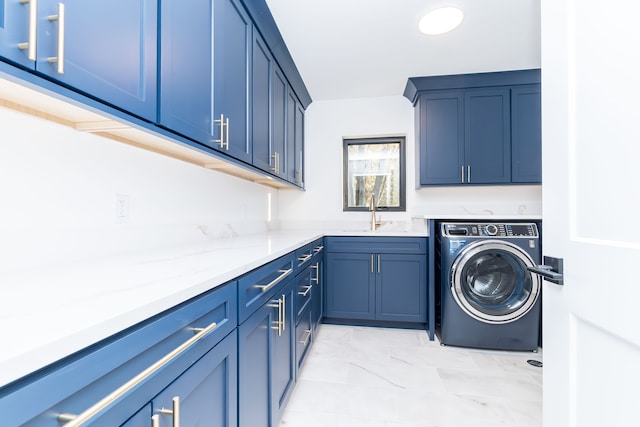 clothes washing area with cabinets, washer / clothes dryer, and sink