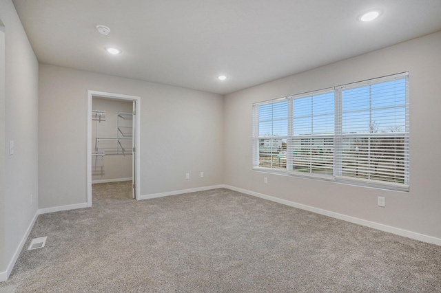 unfurnished room featuring light colored carpet