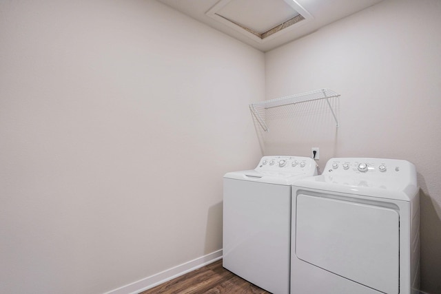 washroom with dark hardwood / wood-style floors and washing machine and clothes dryer