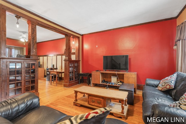 living room featuring ornate columns, crown molding, hardwood / wood-style flooring, and ceiling fan