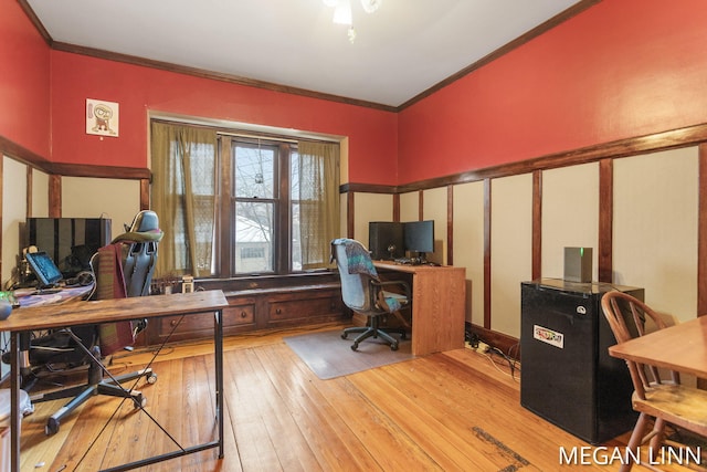 home office with ornamental molding and light hardwood / wood-style floors