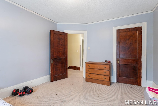 bedroom featuring light carpet, ornamental molding, and a textured ceiling