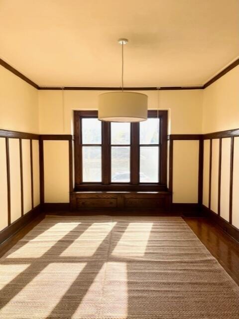 unfurnished room featuring hardwood / wood-style flooring, a healthy amount of sunlight, and ornamental molding