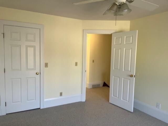 unfurnished bedroom featuring ceiling fan and carpet floors