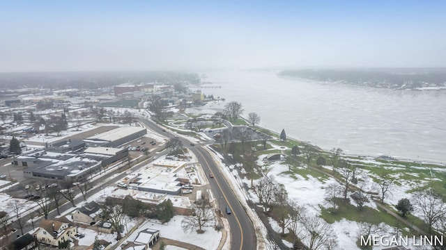 snowy aerial view featuring a water view