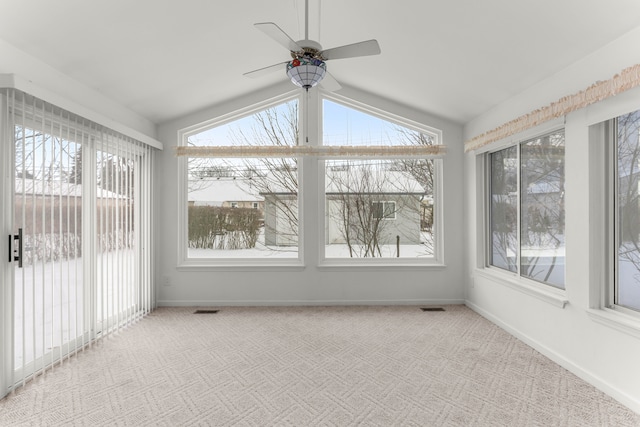 unfurnished sunroom with a healthy amount of sunlight, visible vents, and lofted ceiling