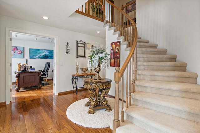 stairs featuring recessed lighting, baseboards, and wood finished floors