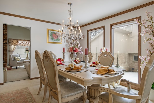 dining room featuring light colored carpet, visible vents, an inviting chandelier, ornamental molding, and baseboards