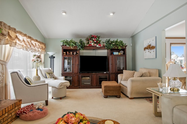 living room with lofted ceiling and light colored carpet