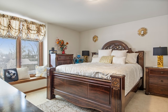 bedroom featuring light carpet and baseboards