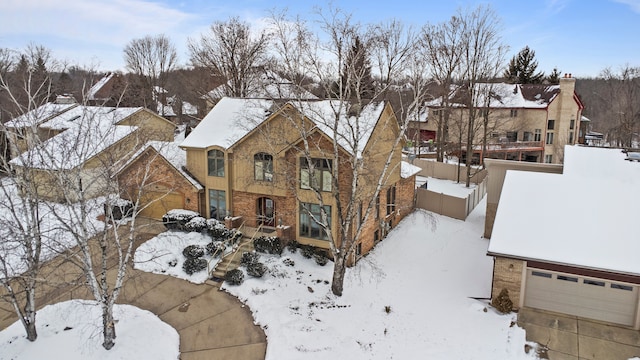 snowy aerial view featuring a residential view