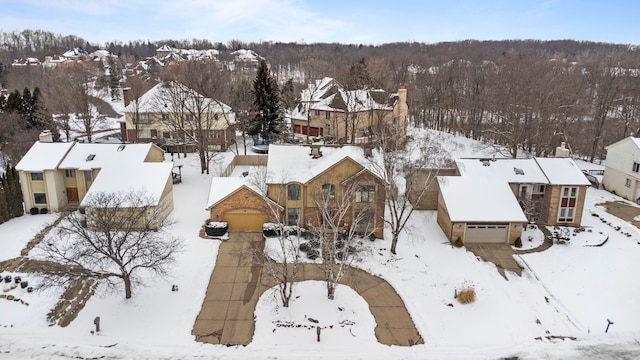 snowy aerial view with a residential view