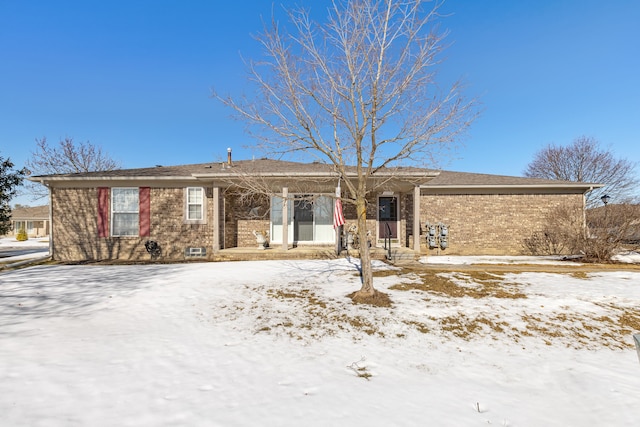 ranch-style house featuring brick siding